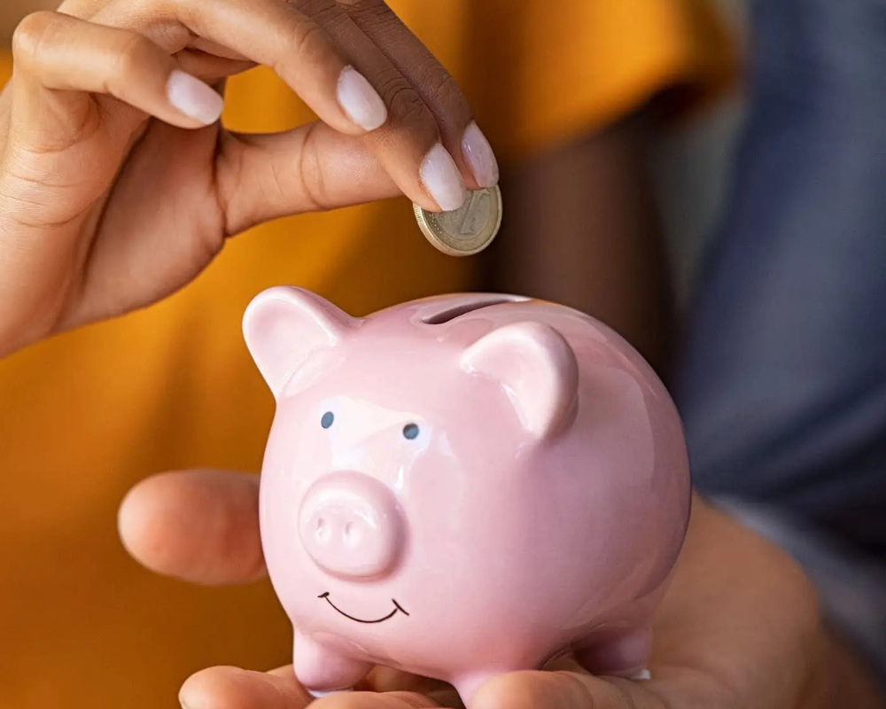 People putting money into a piggy bank